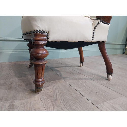 283 - Victorian carved mahogany and leather upholstered His and Her chairs on turned legs and castors. {10... 