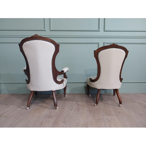 283 - Victorian carved mahogany and leather upholstered His and Her chairs on turned legs and castors. {10... 