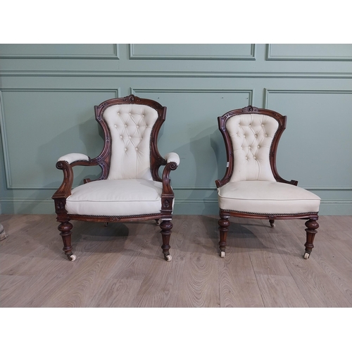 283 - Victorian carved mahogany and leather upholstered His and Her chairs on turned legs and castors. {10... 