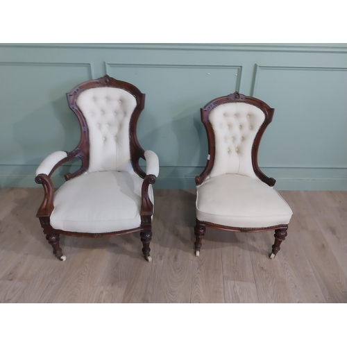 283 - Victorian carved mahogany and leather upholstered His and Her chairs on turned legs and castors. {10... 