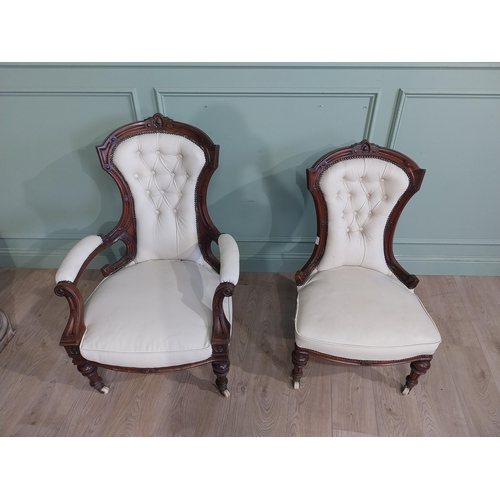 283 - Victorian carved mahogany and leather upholstered His and Her chairs on turned legs and castors. {10... 