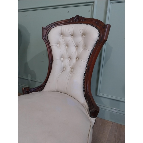 283 - Victorian carved mahogany and leather upholstered His and Her chairs on turned legs and castors. {10... 