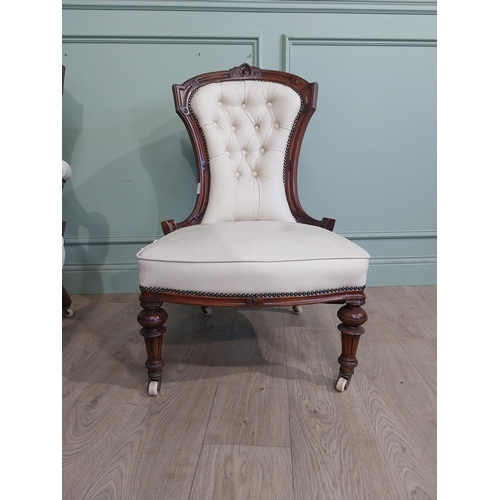 283 - Victorian carved mahogany and leather upholstered His and Her chairs on turned legs and castors. {10... 