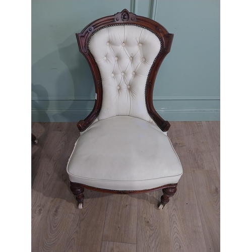 283 - Victorian carved mahogany and leather upholstered His and Her chairs on turned legs and castors. {10... 