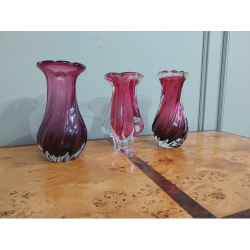 302 - Three ruby glass vases. {24 cm H}