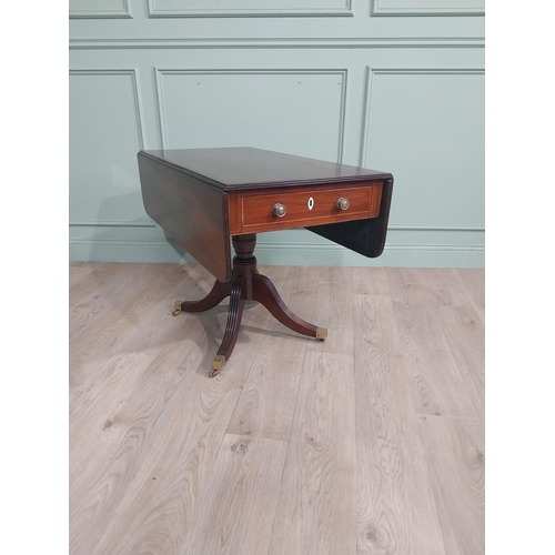 312 - Regency mahogany drop leaf table on single turned column with four reeded outswept feet on castors. ... 