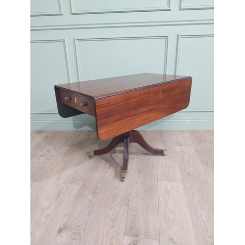 312 - Regency mahogany drop leaf table on single turned column with four reeded outswept feet on castors. ... 