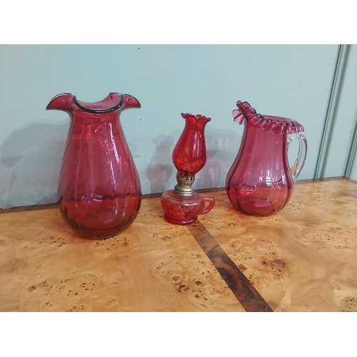 317 - Early 20th C. Ruby glass jug {cracked), thumb lamp and vase. {24 cm H x 22 cm H}