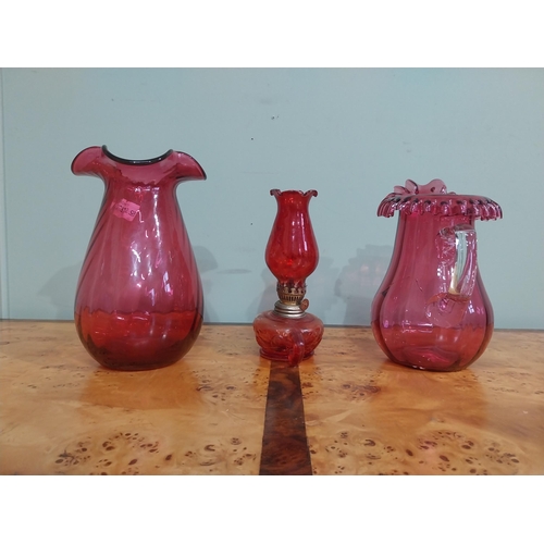 317 - Early 20th C. Ruby glass jug {cracked), thumb lamp and vase. {24 cm H x 22 cm H}