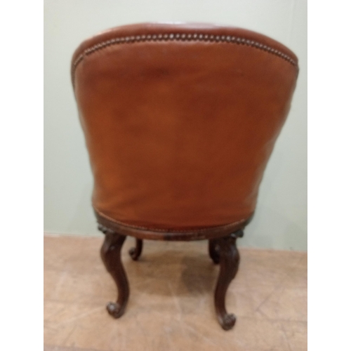 318 - Victorian walnut and upholstered tan leather swivel library chair tan leather cabriole legs and claw... 