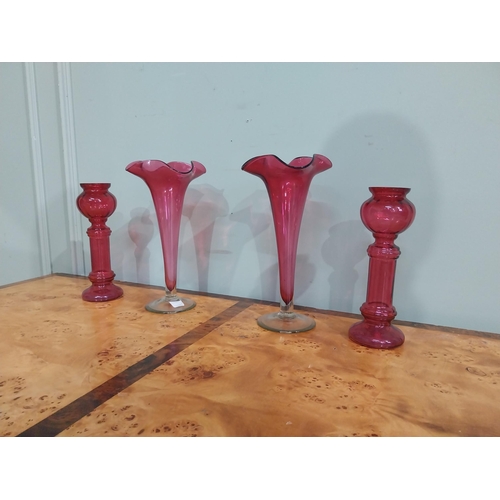 32 - Pair of Victorian ruby glass fluted vases {27 cm H} and two ruby glass candlesticks {22 cm H}.