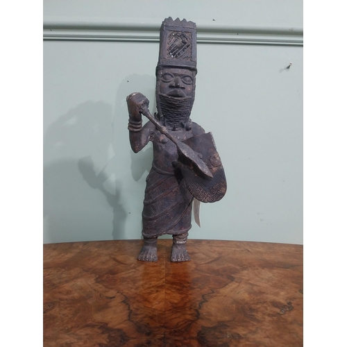 323 - African Benin bronze sculpture. {36 cm H x 12 cm W x 40 cm D}.