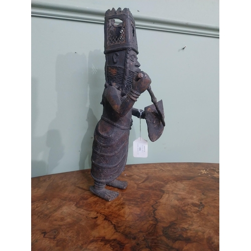 323 - African Benin bronze sculpture. {36 cm H x 12 cm W x 40 cm D}.