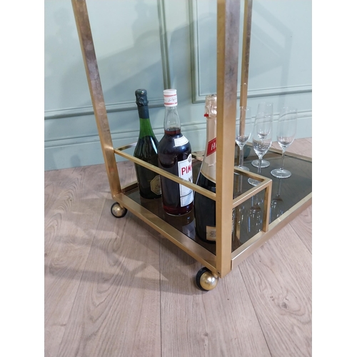 342 - Mid century Italian brass and smoked brass drink�s trolley. {74 cm H x 67 cm W x 45 cm D}.