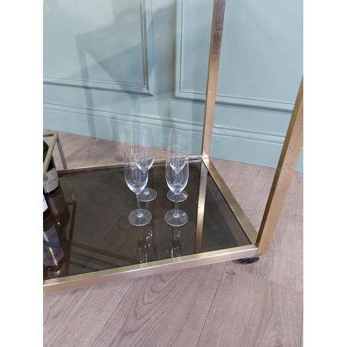 342 - Mid century Italian brass and smoked brass drink�s trolley. {74 cm H x 67 cm W x 45 cm D}.