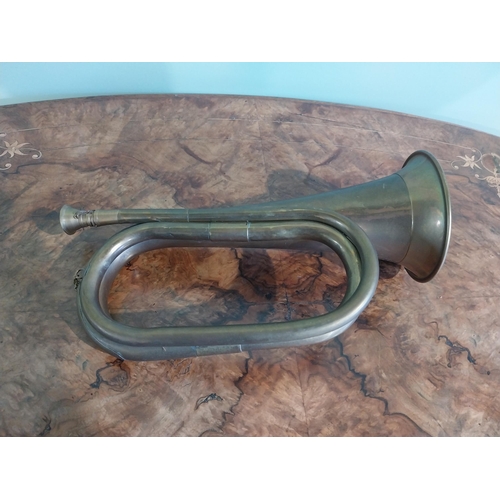 371 - Edwardian brass bugle. {16 cm H x 28 cm W x 10 cm D}.