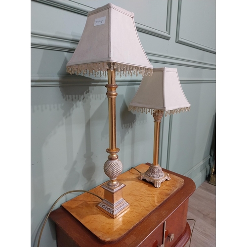 379 - Pair of decorative gilded resin table lamps with cloth shades. {69 cm H and 40 cm H}.