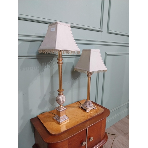 379 - Pair of decorative gilded resin table lamps with cloth shades. {69 cm H and 40 cm H}.