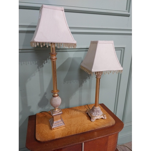 379 - Pair of decorative gilded resin table lamps with cloth shades. {69 cm H and 40 cm H}.