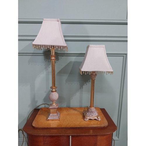 379 - Pair of decorative gilded resin table lamps with cloth shades. {69 cm H and 40 cm H}.