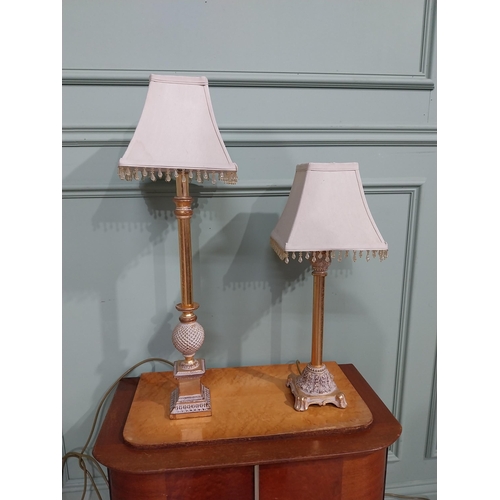 379 - Pair of decorative gilded resin table lamps with cloth shades. {69 cm H and 40 cm H}.