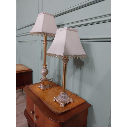 379 - Pair of decorative gilded resin table lamps with cloth shades. {69 cm H and 40 cm H}.