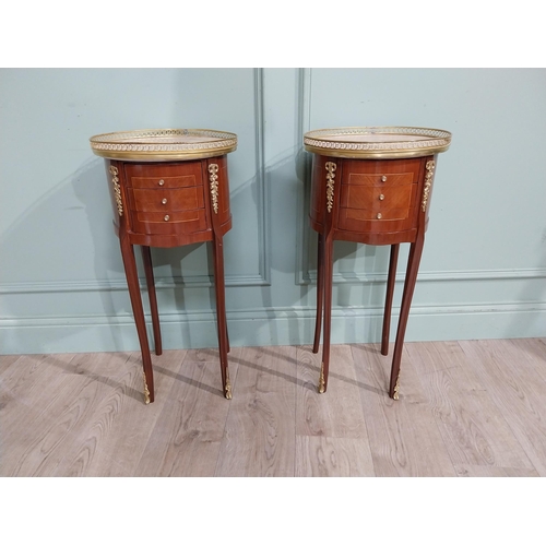 395 - Pair of French kingwood beside cabinets with marble tops and brass gallery with ormolu mounts in the... 