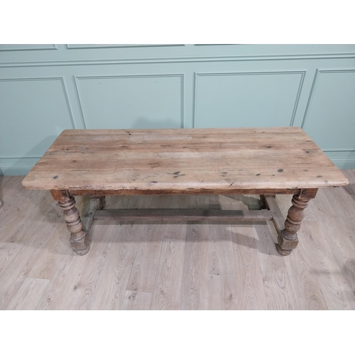 43 - 19th C. French oak kitchen table on turned legs with single stretcher. {76 cm H x 195 cm W x 79 cm}.