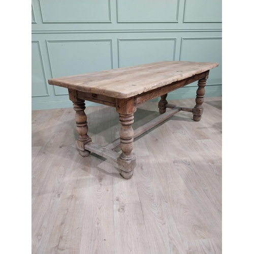 43 - 19th C. French oak kitchen table on turned legs with single stretcher. {76 cm H x 195 cm W x 79 cm}.