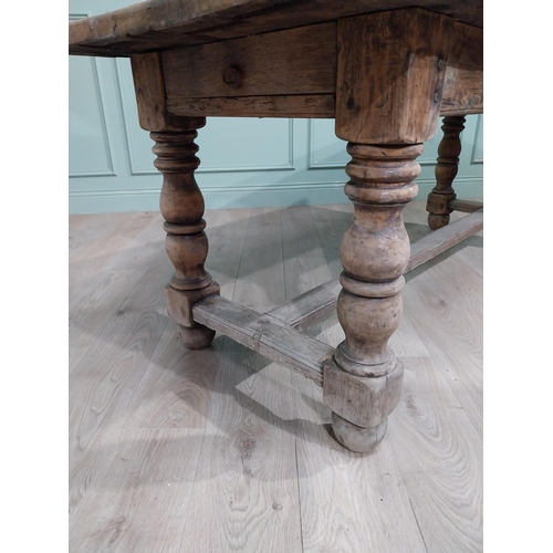 43 - 19th C. French oak kitchen table on turned legs with single stretcher. {76 cm H x 195 cm W x 79 cm}.