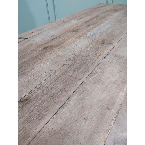 43 - 19th C. French oak kitchen table on turned legs with single stretcher. {76 cm H x 195 cm W x 79 cm}.