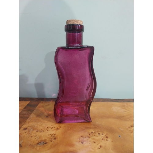 439 - Two shaped ruby glass bottles and vase. {20 cm H} and {18 cm H}