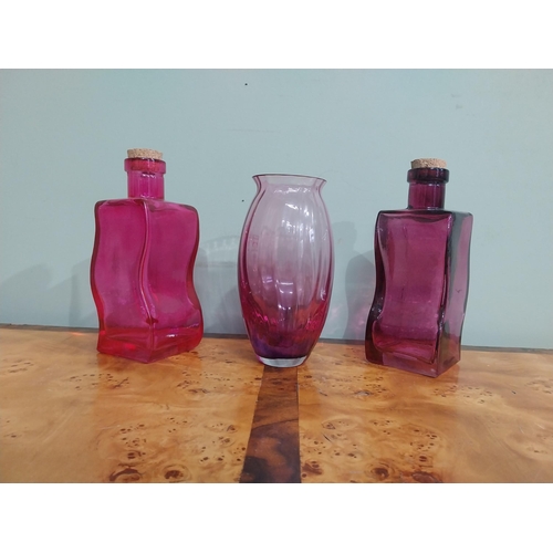 439 - Two shaped ruby glass bottles and vase. {20 cm H} and {18 cm H}