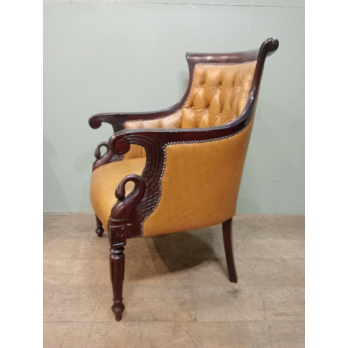 451 - Mahogany tan leather deep buttoned armchair with swan decoration with shaped legs. {H 97cm x W 65cm ... 