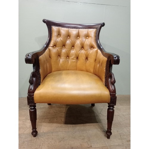 451 - Mahogany tan leather deep buttoned armchair with swan decoration with shaped legs. {H 97cm x W 65cm ... 