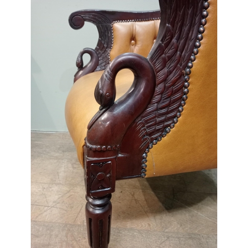 451 - Mahogany tan leather deep buttoned armchair with swan decoration with shaped legs. {H 97cm x W 65cm ... 