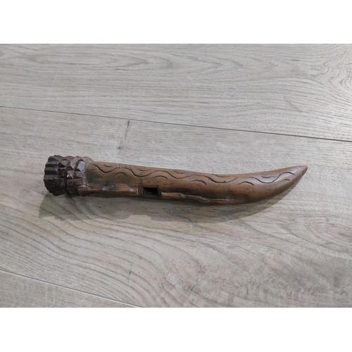 501 - Carved African hardwood sheath. {24 cm L}.