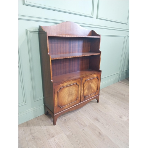 504 - Good quality mahogany waterfall bookcase in the Georgian style with two doors raised on shaped feet.... 