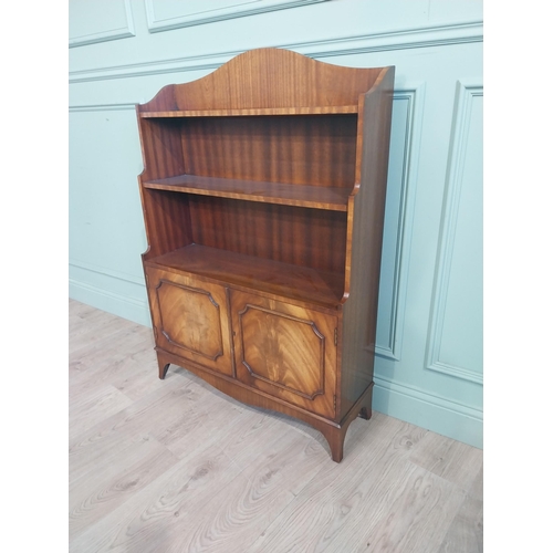 504 - Good quality mahogany waterfall bookcase in the Georgian style with two doors raised on shaped feet.... 