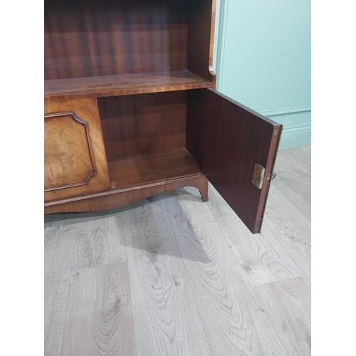 504 - Good quality mahogany waterfall bookcase in the Georgian style with two doors raised on shaped feet.... 