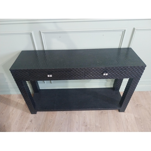 534 - Designer ebonised console table with two drawers in frieze with platform base and square legs. {85 c... 