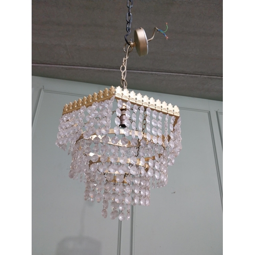 547 - 1950�s French gilded brass and crystal drop three tier chandelier. {54 cm H x 27 cm Dia.}.