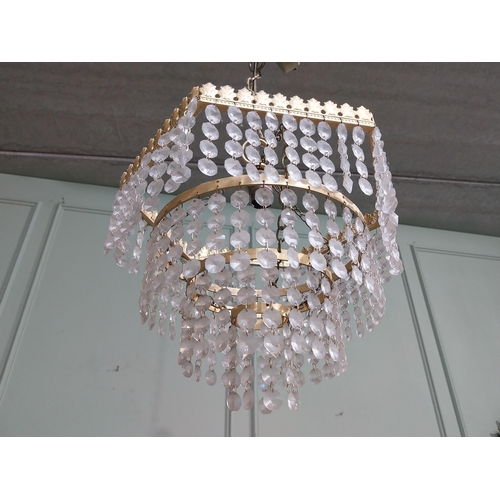 547 - 1950�s French gilded brass and crystal drop three tier chandelier. {54 cm H x 27 cm Dia.}.