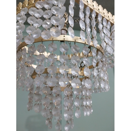 547 - 1950�s French gilded brass and crystal drop three tier chandelier. {54 cm H x 27 cm Dia.}.