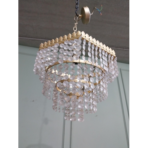 547 - 1950�s French gilded brass and crystal drop three tier chandelier. {54 cm H x 27 cm Dia.}.