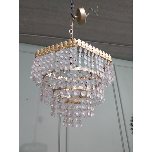 547 - 1950�s French gilded brass and crystal drop three tier chandelier. {54 cm H x 27 cm Dia.}.