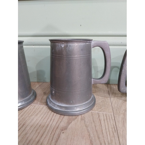 548 - Five pewter tankards one with fishing reference �the one that got away�. {13 cm H x 12 cm Dia.}.