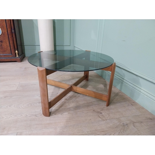 56 - Mid century teak and tinted glass coffee table. {37 cm H x 72 cm Dia.}.