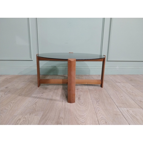 56 - Mid century teak and tinted glass coffee table. {37 cm H x 72 cm Dia.}.