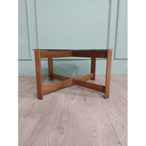 56 - Mid century teak and tinted glass coffee table. {37 cm H x 72 cm Dia.}.